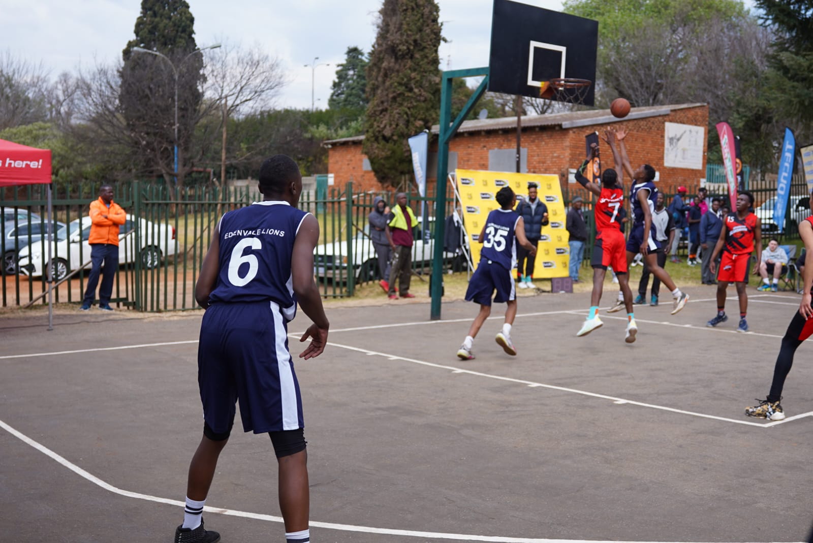 Players contest a shot at the outdoor tournament court